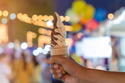 Close-up of hand holding illuminated lighting equipment