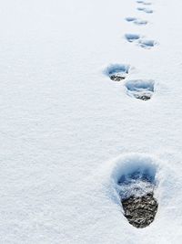 High angle view of footprints on snow covered land