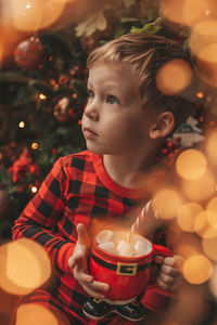 Portrait of boy playing christmas tree