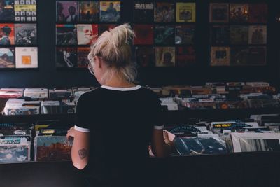 Rear view of woman standing in store