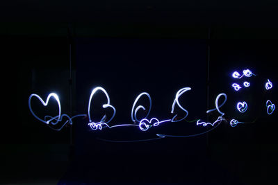 Illuminated light painting on wall at night