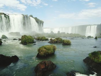 Scenic view of waterfall against sky