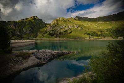 Scenic view of lake and mountains against sky