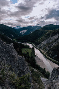 Scenic view of river amidst mountains against sky