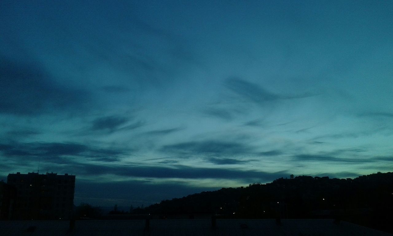 sky, silhouette, cloud - sky, tranquility, tranquil scene, scenics, beauty in nature, dusk, cloudy, landscape, nature, cloud, blue, tree, dark, sunset, weather, dramatic sky, idyllic, outdoors