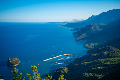 High angle view of sea and mountains against clear sky