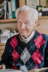 Portrait of man sitting at home