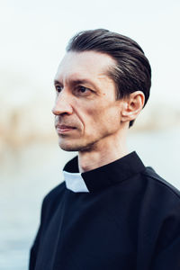 Close-up of serious mature priest