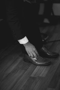 Low section of woman standing on hardwood floor