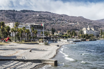 Scenic view of sea and buildings against sky