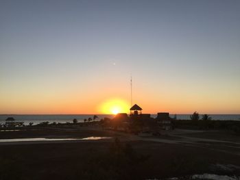 Scenic view of sea against clear sky during sunset