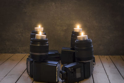 Close-up of illuminated candles on cameras