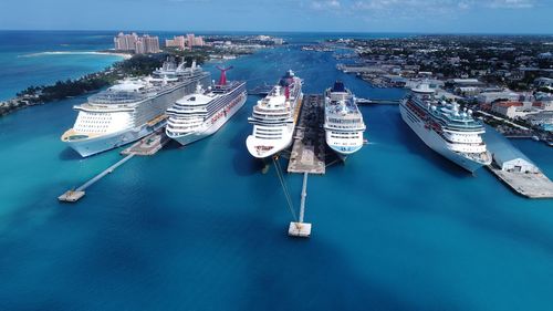 High angle view of boats moored in sea against blue sky