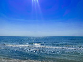 Scenic view of sea against blue sky