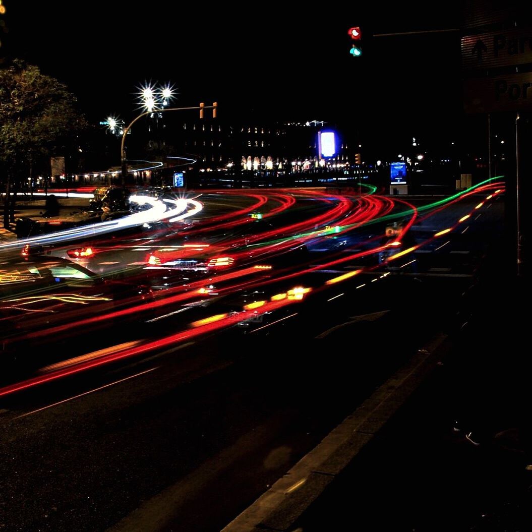 LIGHT TRAILS ON ROAD IN NIGHT