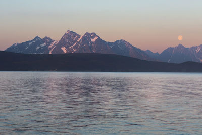 Sunset over lyngen alps with full moon