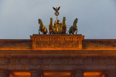 Low angle view of statue against building