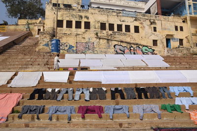 Low angle view of clothes drying against building