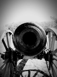 Low angle view of rusty wheel against clear sky