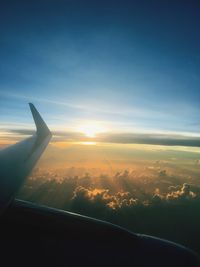 Airplane flying over landscape against sky