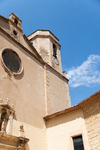 Low angle view of historic building against blue sky