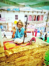 Portrait of woman sitting in market