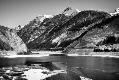 Scenic view of lake and mountains against clear sky