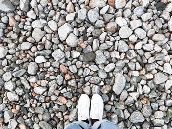 Low section of man standing on stones