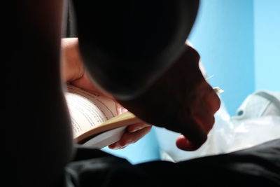 Close-up of hand holding book