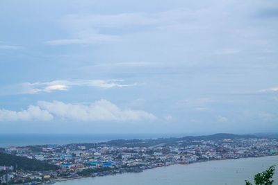 High angle view of townscape by sea against sky