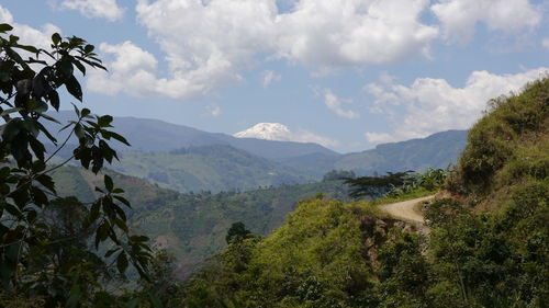 Scenic view of mountains against cloudy sky