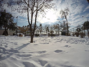 Snow covered landscape against sky