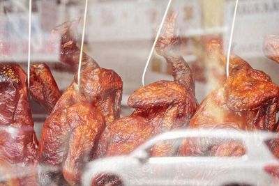 Close-up of roasted duck meat at window display