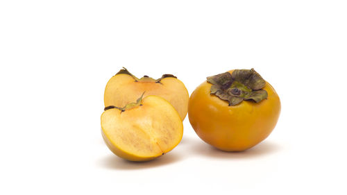 Close-up of orange fruit against white background