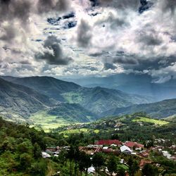 Scenic view of mountains against cloudy sky