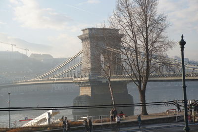 Bridge over river with buildings in background