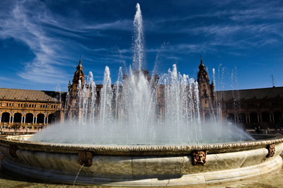 Panoramic view of fountain against buildings in city