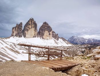 Wooden handrail and sign on trekking path at dolomites mountains at the italy. tre cime di lavaredo