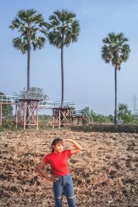 Beautiful woman standing with rural screen on background.