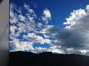 Low angle view of mountain against cloudy sky