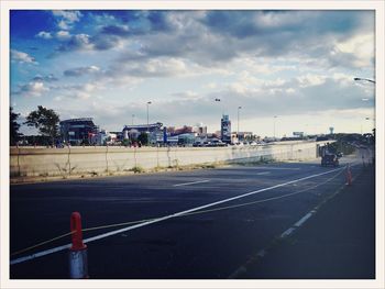 City street against cloudy sky
