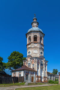 Low angle view of building against clear blue sky