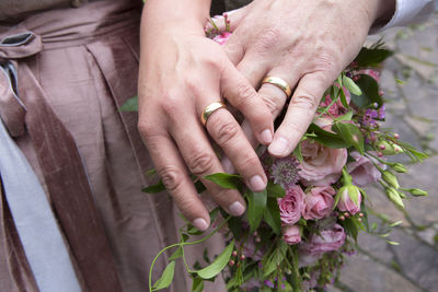 Cropped image of couple holding hands