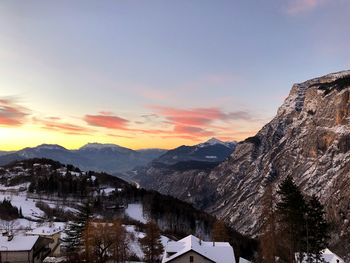 Scenic view of snowcapped mountains against sky during sunset