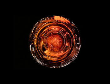 Close-up of beer glass against black background