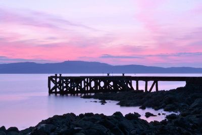 Scenic view of lake against cloudy sky