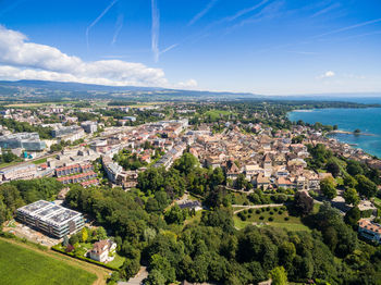 High angle view of townscape by sea against sky