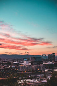 High angle view of buildings against cloudy sky