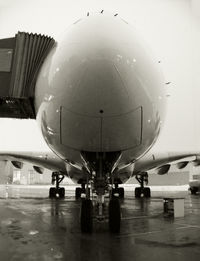 Airplane on airport runway against sky