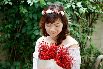 Portrait of woman with red flower